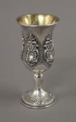 A silver gilded Jewish Kiddush cup with embossed design. 11 cm high. 75.6 grammes.