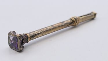 A Victorian propelling pencil with amethyst seal. 9.5 cm long when closed.