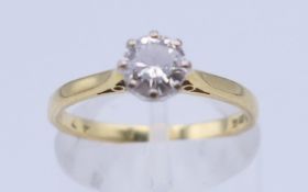 An 18 ct gold diamond solitaire ring. The stone spreading to approximately 0.5 carat. Ring size M/N.