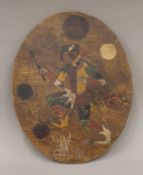 An oval wooden panel painted with a Jester and inscribed 'Xmas Greetings'. 31 cm high.