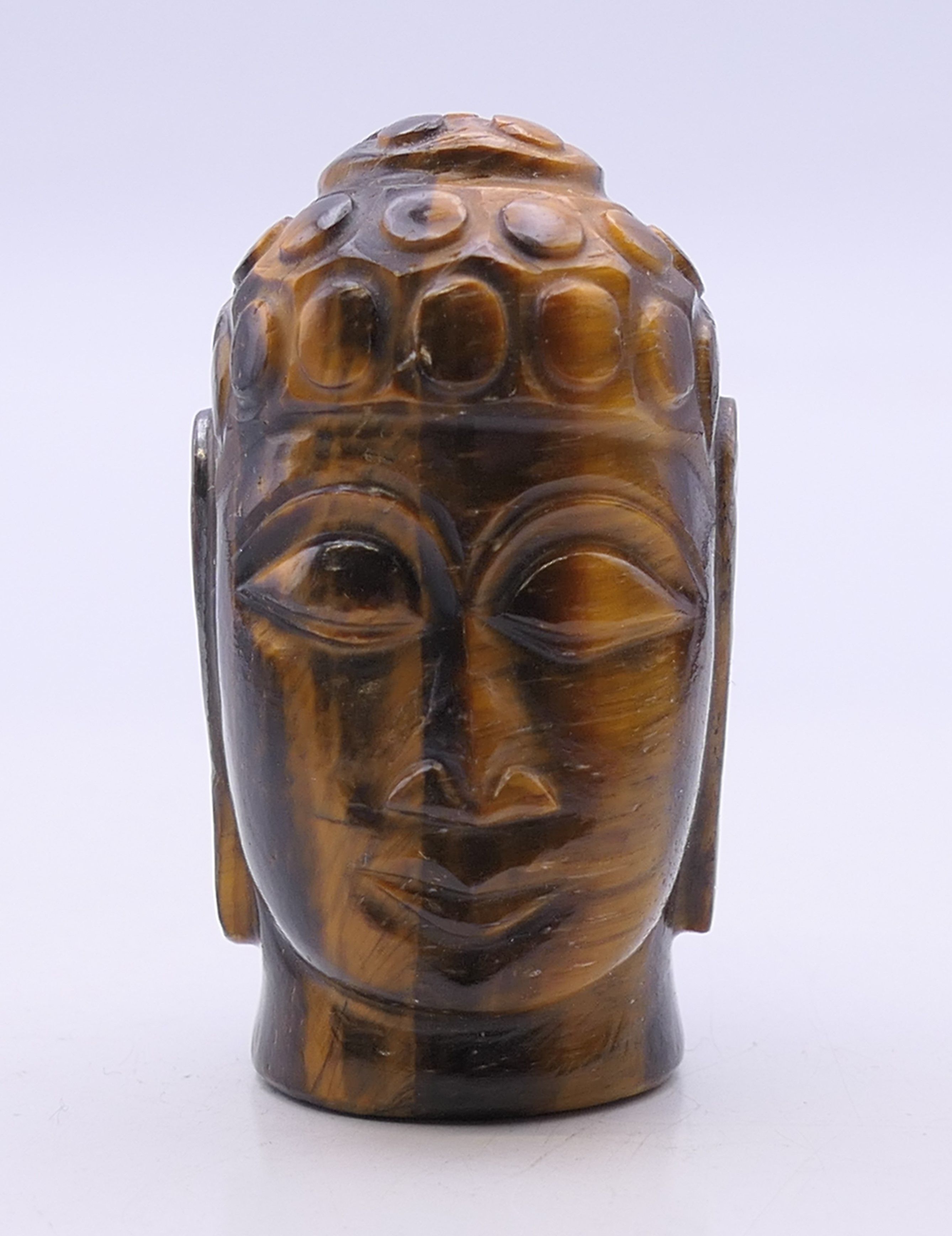 A tigerseye bust of Buddha. 5.5 cm high.