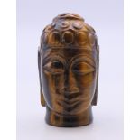 A tigerseye bust of Buddha. 5.5 cm high.