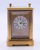 A miniature porcelain mounted carriage clock. 7 cm high.