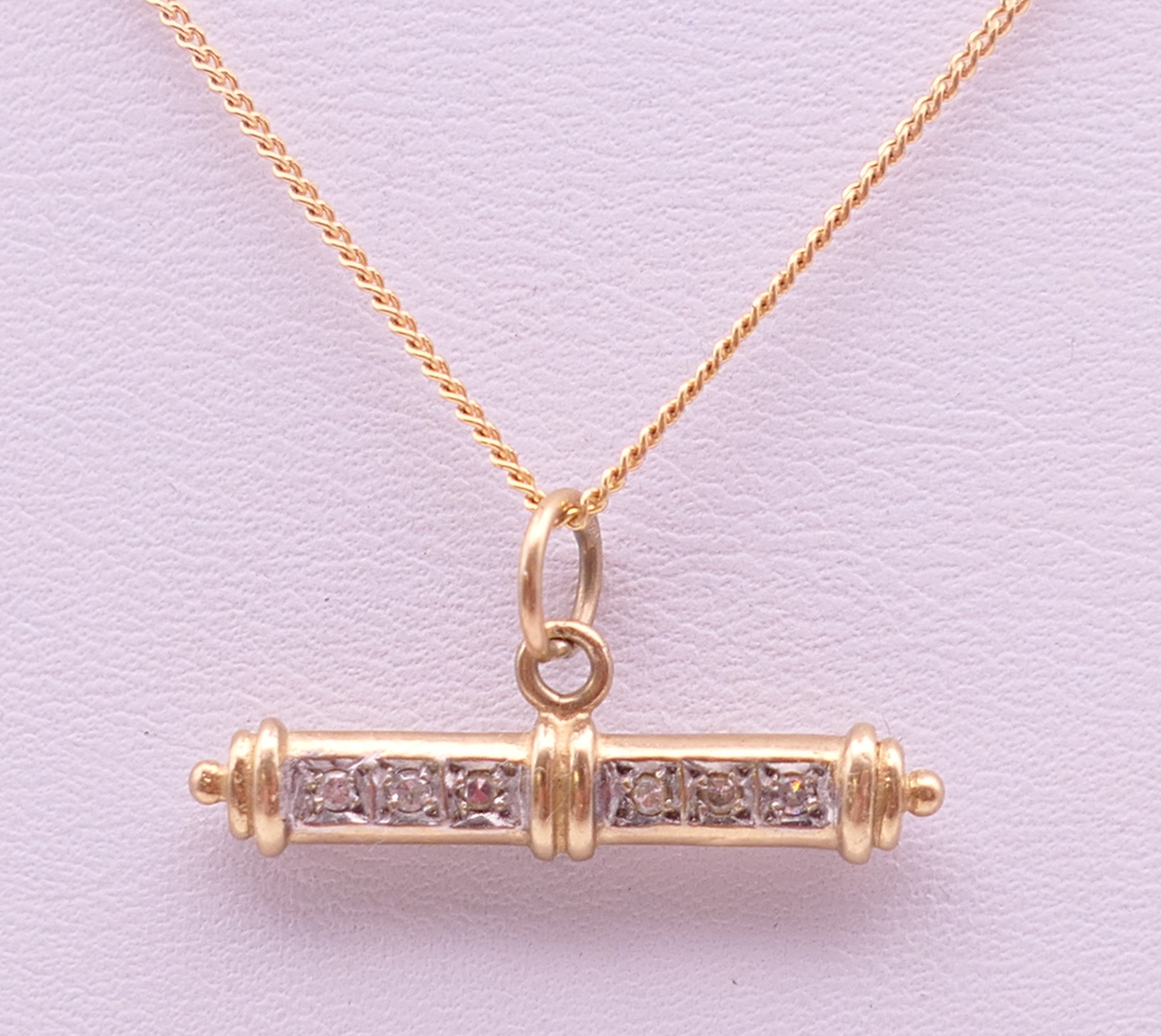 A 9 ct gold diamond set T-bar on a 9 ct gold chain. Bar 2.5 cm long, chain 41 cm long. 3.