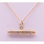 A 9 ct gold diamond set T-bar on a 9 ct gold chain. Bar 2.5 cm long, chain 41 cm long. 3.