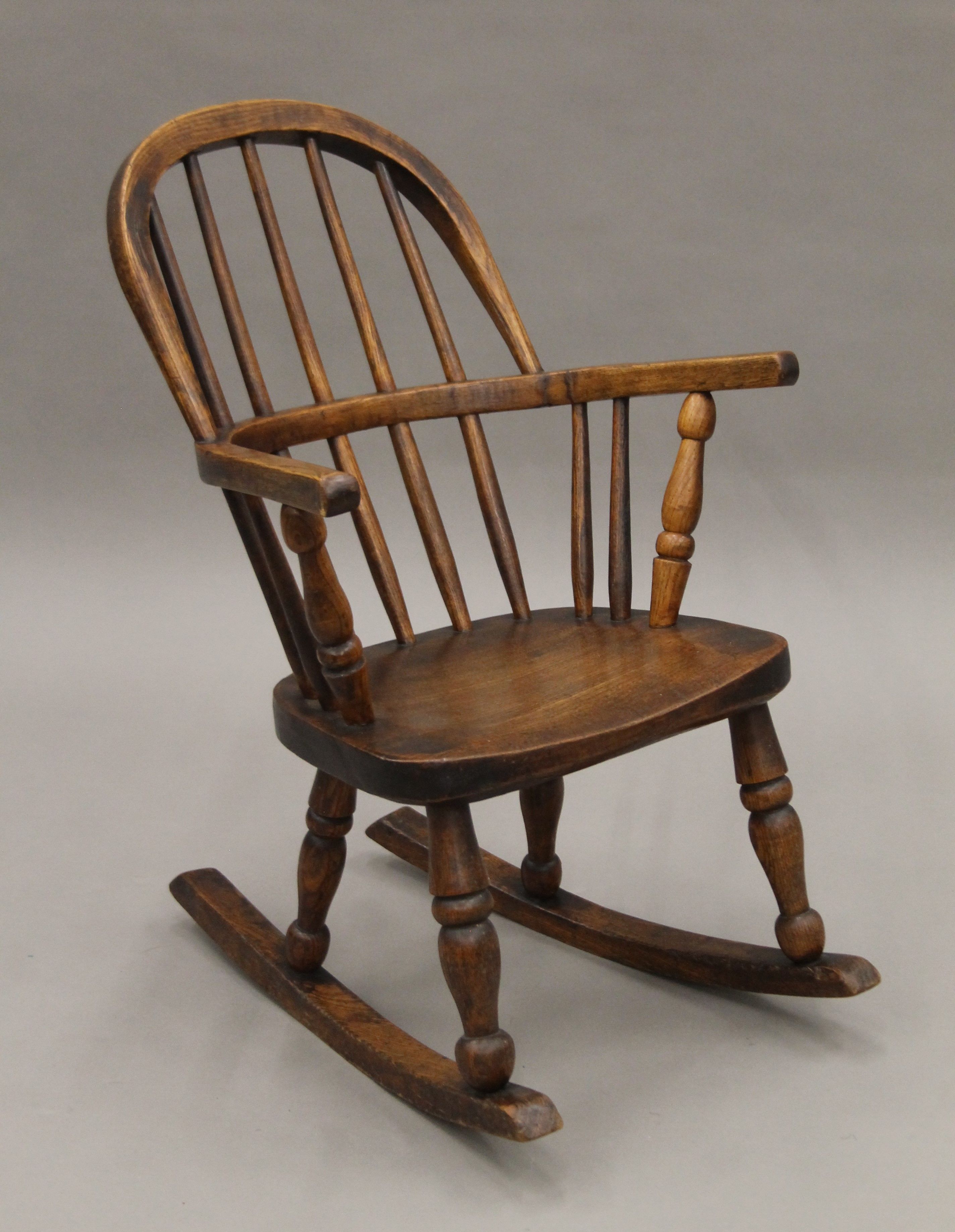 A Victorian elm child's stick back open arm rocking chair. - Image 2 of 4
