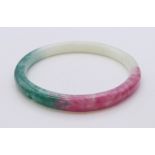 A multi-coloured jade bangle. Approximately 7 cm internal diameter.