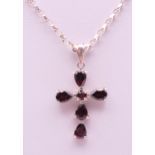 A garnet cross pendant on a silver chain. Pendant 2.