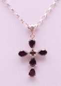 A garnet cross pendant on a silver chain. Pendant 2.