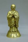 A 19th century Oriental brass figure of a Buddhist Monk. 22.5 cm high.