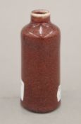 A small 18th century Chinese porcelain sang de boeuf cylindrical bottle vase. 9.5 cm high.