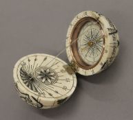 A bone globe compass. 7 cm high.