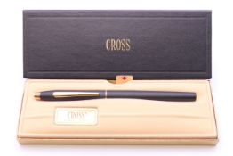 A boxed Cross roller ball pen.