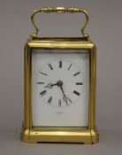 A French brass carriage clock, the dial inscribed 'HY MARK PARIS'. 14 cm high.
