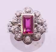 A 14 ct white gold ruby and diamond cluster ring. Ring size R/S.