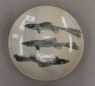 A Japanese Studio Pottery dish decorated with fish. 31 cm diameter.