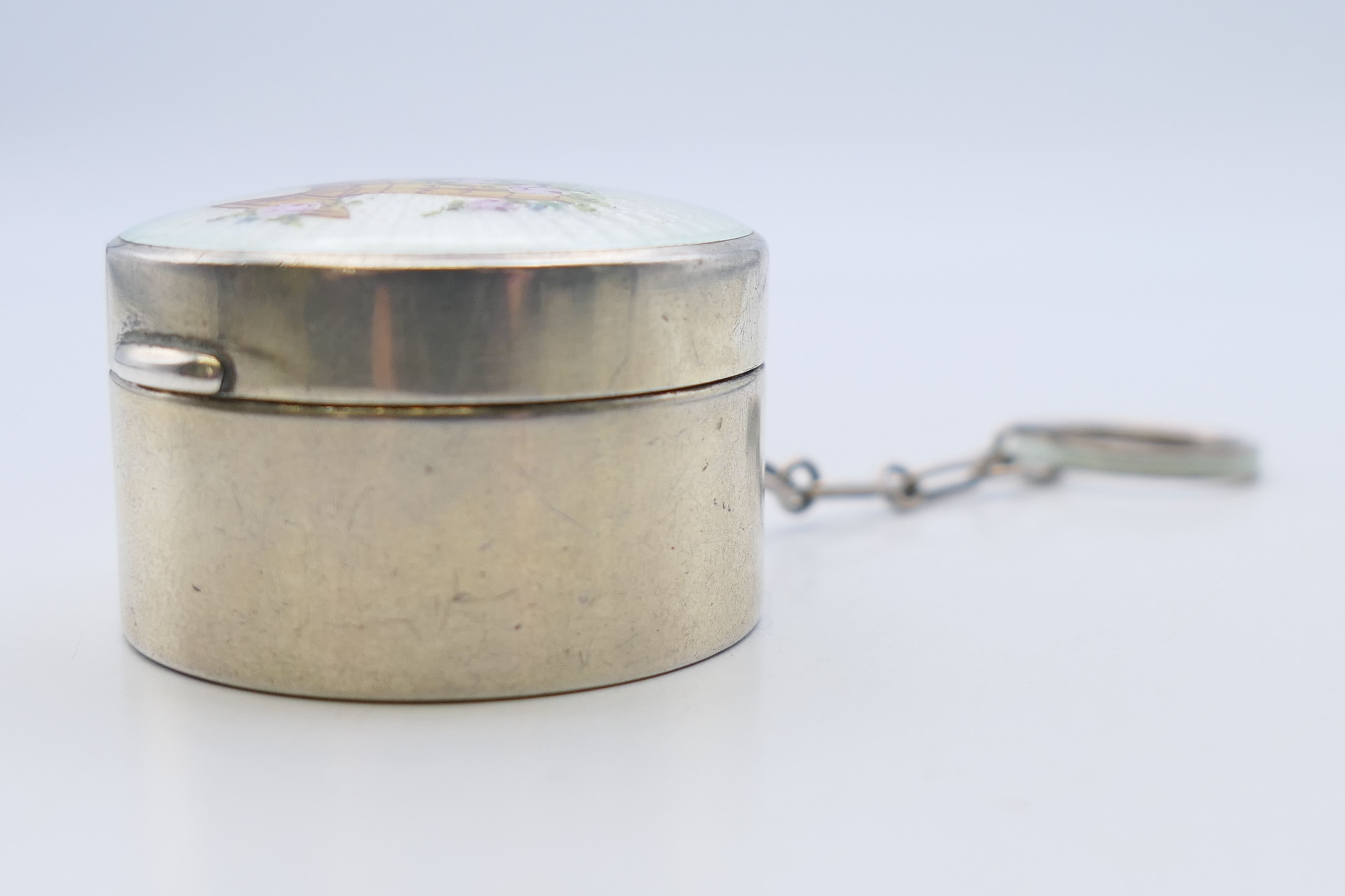 An early 20th century enamel decorated silver pill box. 4 cm diameter. - Image 3 of 5