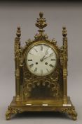 A Victorian Gothic Revival brass mantle clock. 51 cm high.