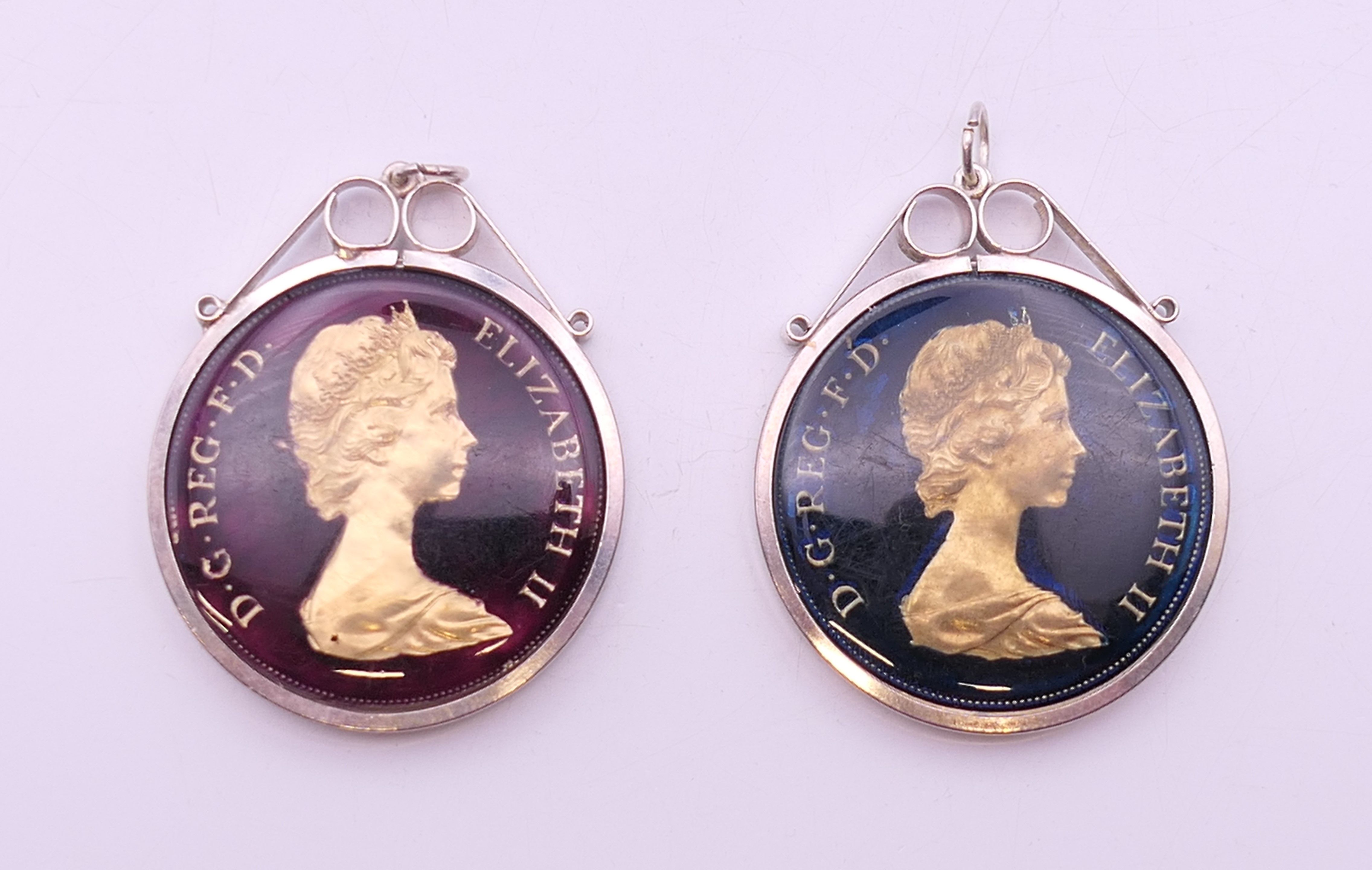 Two Queen Elizabeth II enamelled crowns, in silver mounts. Each 4.5 cm high including mount.
