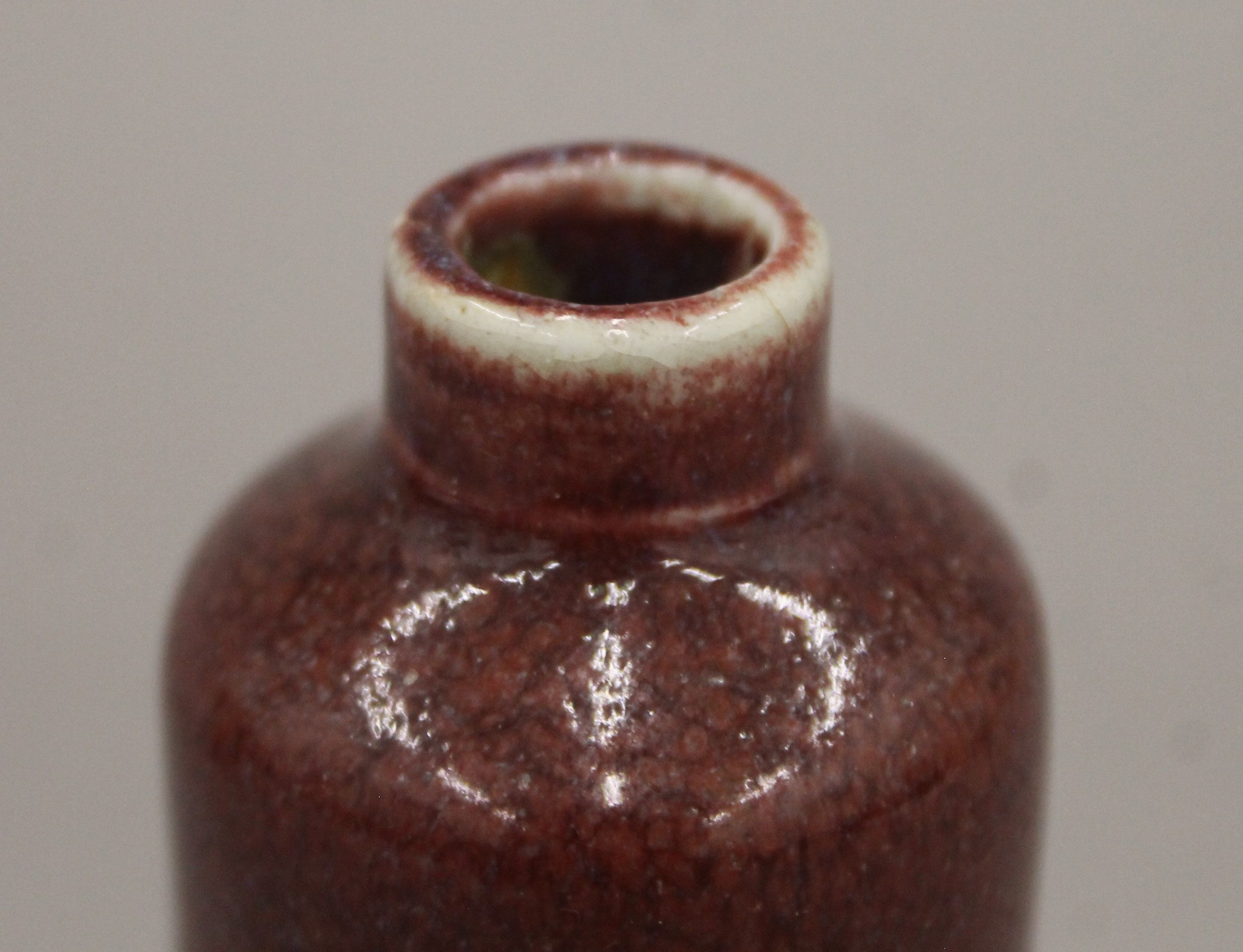 A small 18th century Chinese porcelain sang de boeuf cylindrical bottle vase. 9.5 cm high. - Image 3 of 4