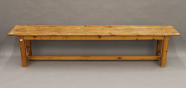 A pine bench. 203 cm long.