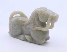 A jade carving of a recumbent horse. 8 cm long.