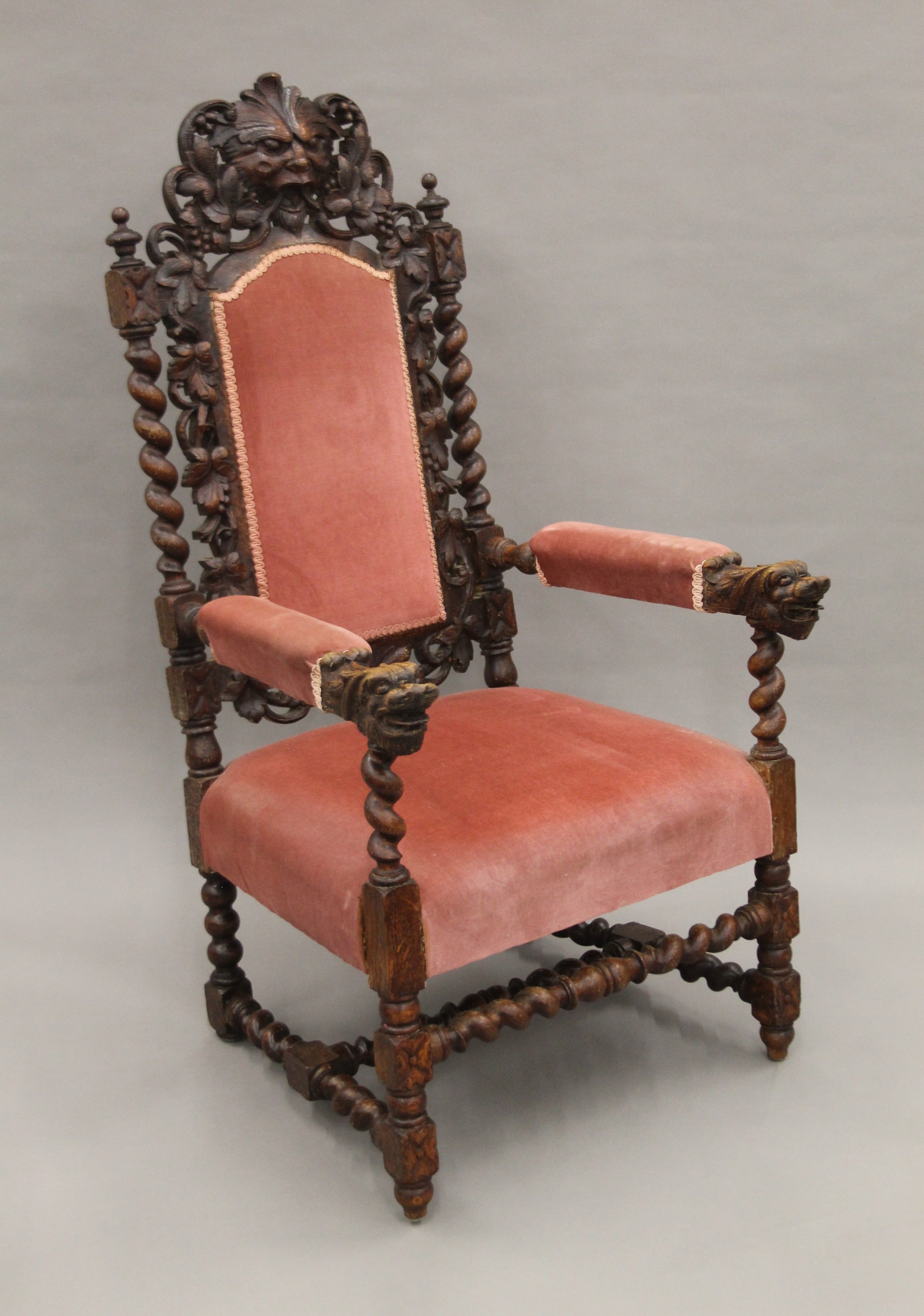 A 19th century carved oak upholstered open armchair with greenman back and dolphin form arms. - Image 3 of 7