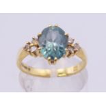 An 18 ct gold aquamarine and diamond ring. Ring size M/N.