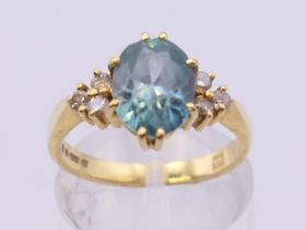 An 18 ct gold aquamarine and diamond ring. Ring size M/N.