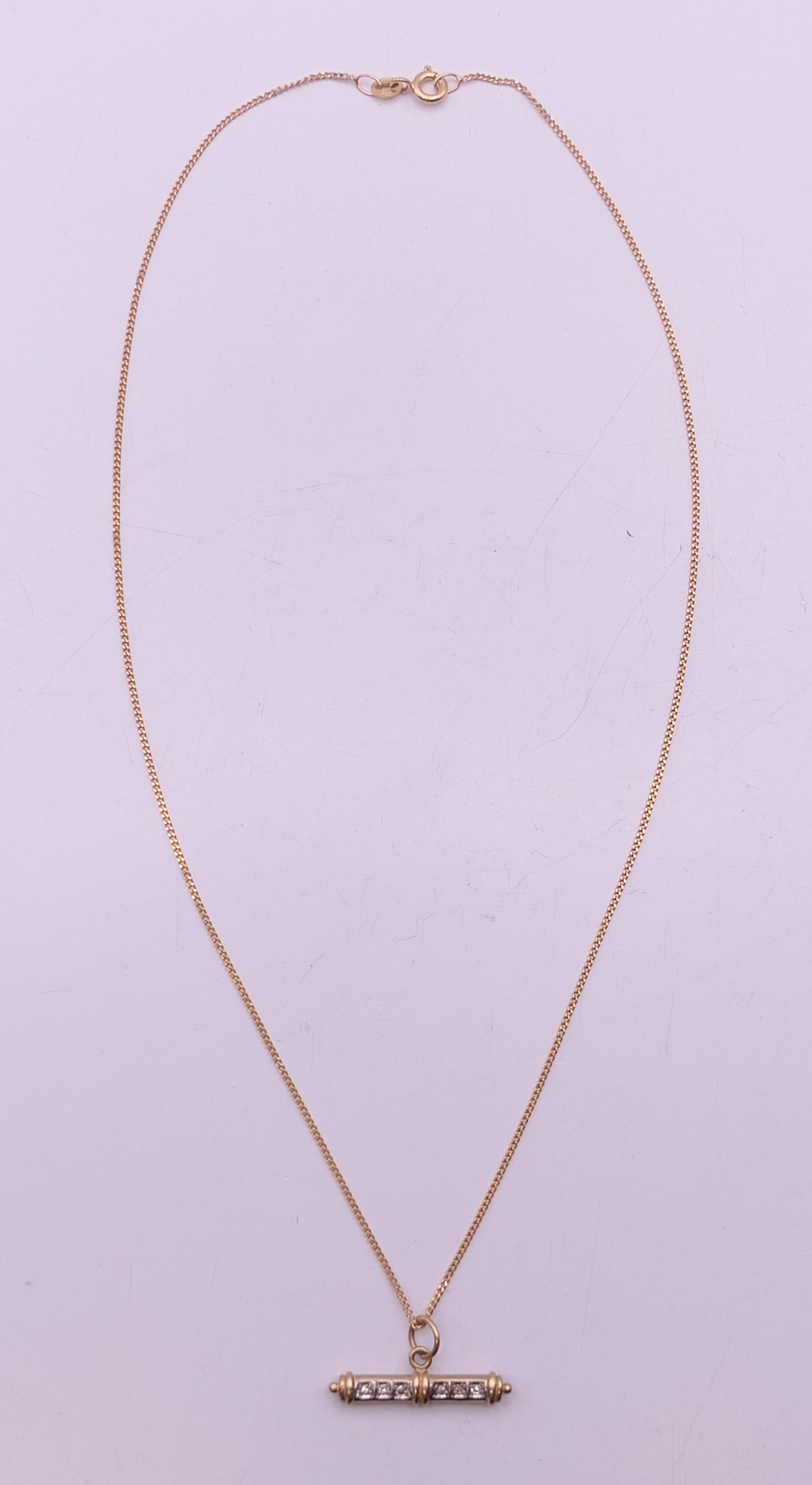 A 9 ct gold diamond set T-bar on a 9 ct gold chain. Bar 2.5 cm long, chain 41 cm long. 3. - Image 2 of 6