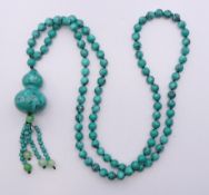 A turquoise pendant bead necklace. 84 cm long.