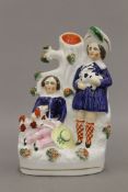 A 19th century Staffordshire spill vase figure with bocage formed by a girl standing and holding a