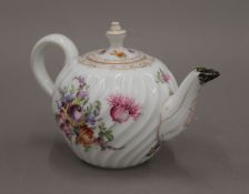 A 19th century Dresden teapot decorated with flowers. 14.5 cm long.
