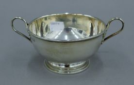 A twin handled silver bowl. 17 cm wide. 191.5 grammes.