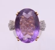 An unmarked 9 ct gold amethyst and diamond ring. Ring size L/M.
