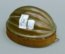 A Victorian steel and copper pudding mould. 14.5 cm long.