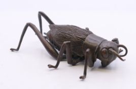 A bronze articulated model of a locust. 7.5 cm long.