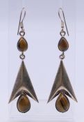 A pair of silver and tigerseye abstract earrings. 5 cm high.