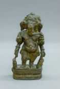 An Indian Hindhu bronze figure of a multi-armed Ganesh, on a lotus leaf base. 18 cm high.