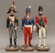 Three models of Napoleonic War soldiers. The largest 54 cm high.