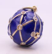 A silver blue enamel ball locket. 2 cm high.