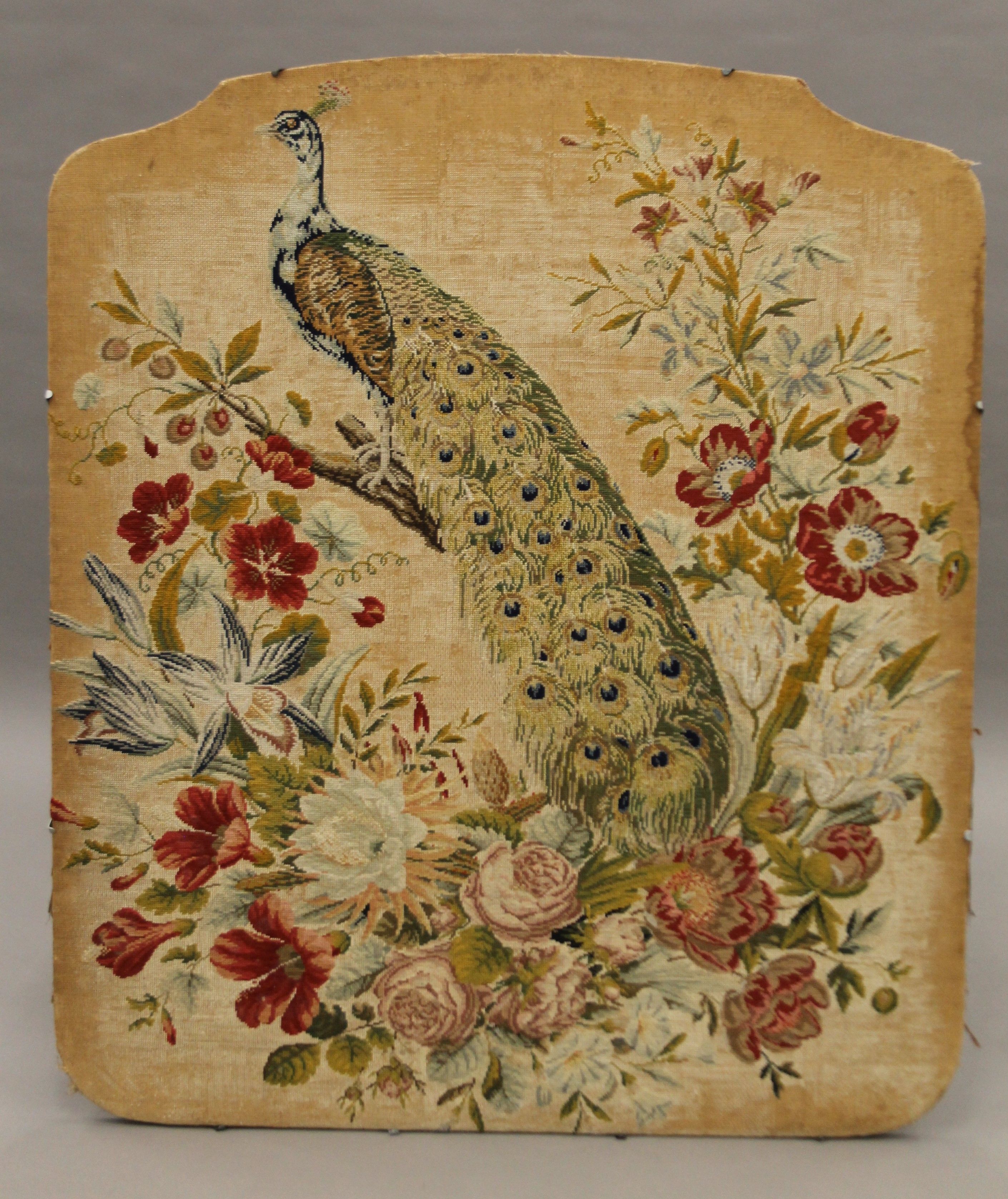 A late 19th/early 20th century panel embroidered with a peacock. 89 cm wide.