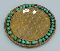 A solitaire board with malachite marbles. The board 28 cm diameter.