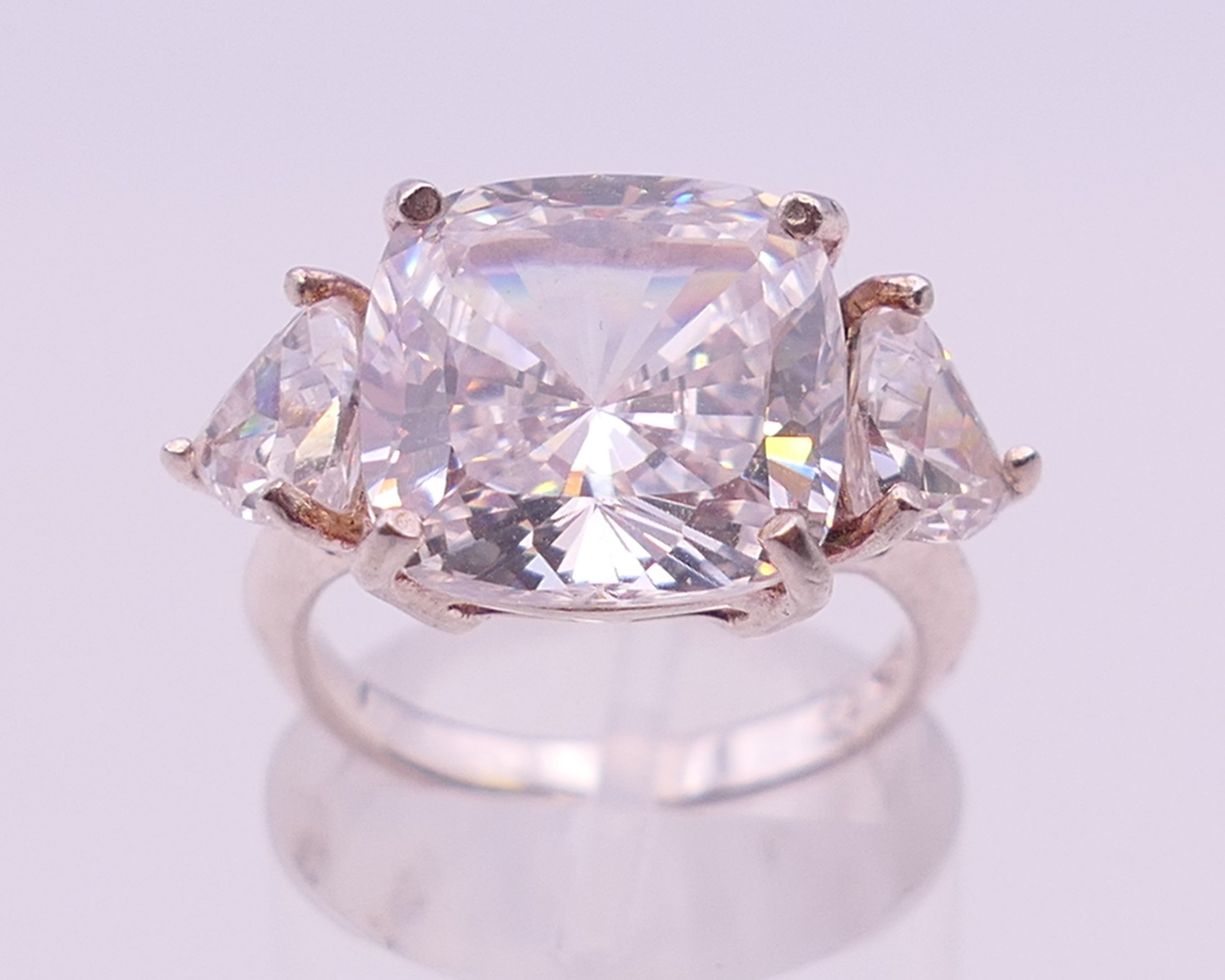 A silver cubic zirconia three stone ring. Ring size K/L.
