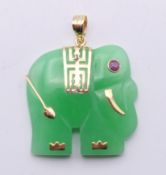A 14 K gold mounted jade pendant formed as an elephant. 2.5 cm wide.
