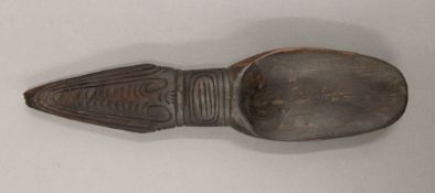 A South Seas carved wooden spoon. 23.5 cm long.