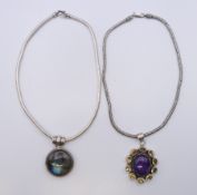 Two silver pendant necklaces. The largest pendant 5.5 cm high.