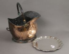 A copper coal scuttle and a silver plated salver. The former 25 cm high.