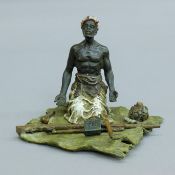 A cold painted bronze model of a North African figure. 9.5 cm high.