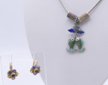 A Chinese silver and enamel pendant necklace and a pair of earrings. The pendant 3.5 cm high.